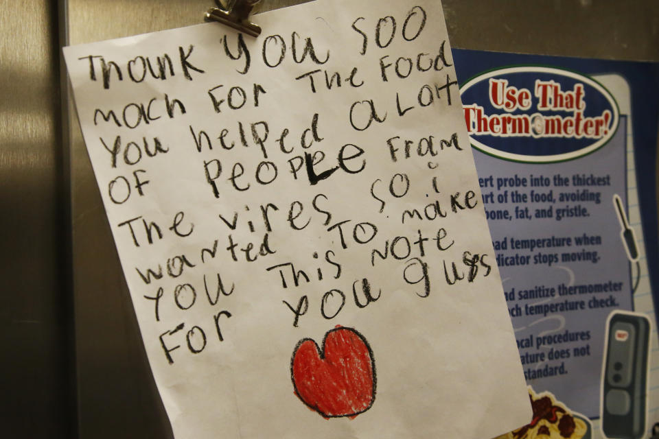 FILE - In this Monday, April 20, 2020, file photo, a thank you note hangs in the kitchen of the Prairie Queen Elementary School in Oklahoma City as lunches and instructional packets are distributed. Oklahoma City Schools are operating remotely through the end of the school year due to COVID-19 concerns. (AP Photo/Sue Ogrocki)