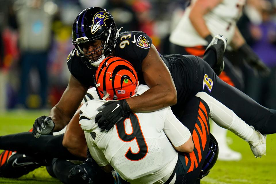 Baltimore Ravens' Calais Campbell (93) sacks Cincinnati Bengals quarterback Joe Burrow during the first half of an NFL football game, Sunday, Oct. 9, 2022, in Baltimore. (AP Photo/Julio Cortez)