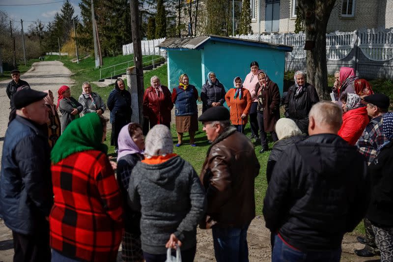 Supporters and opponents of their village's church switch from the Ukrainian Orthodox Church to the Orthodox Church of Ukraine talk in the village of Karyshkiv