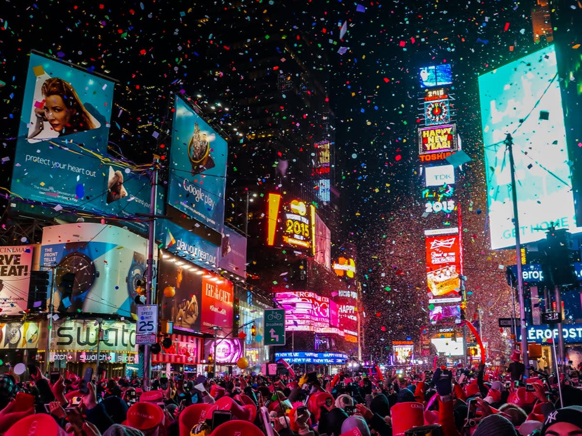 The Times Square ball drops in front of thousands at midnight on 31 December (Getty Images)