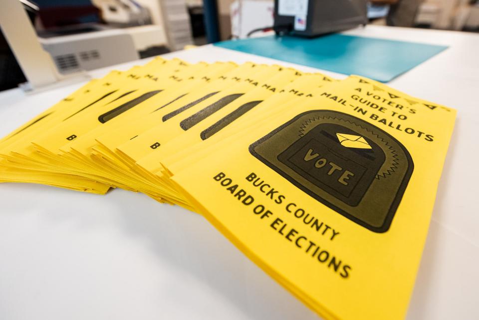 Mail-in ballot guides sit in a stack at the Bucks County Board of Elections office, in Doylestown Borough, on Wednesday, August 30, 2024.