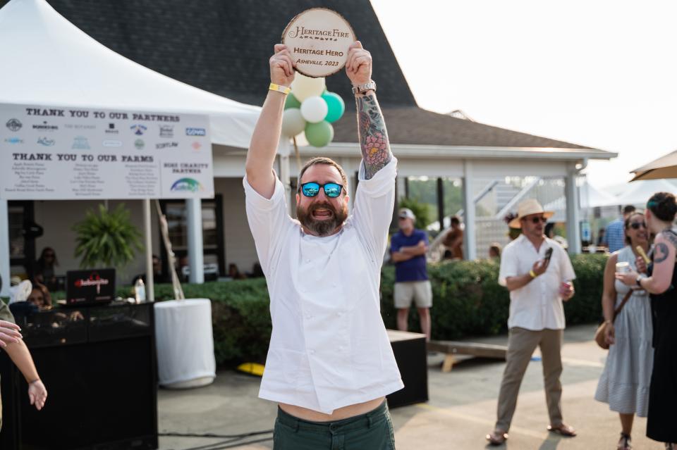 Chef Michael Lewis holds his "Heritage Hero" award.