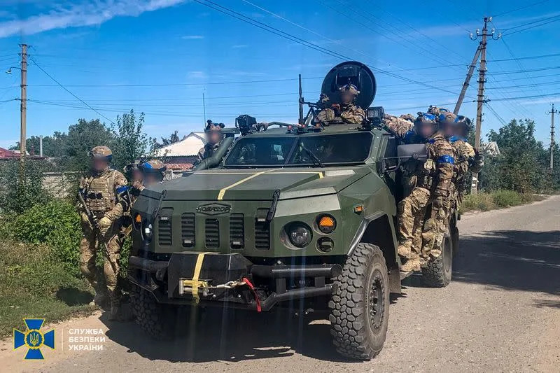 Service members of the State Security Service of Ukraine patrol of an area of the recently liberated town of Kupiansk
