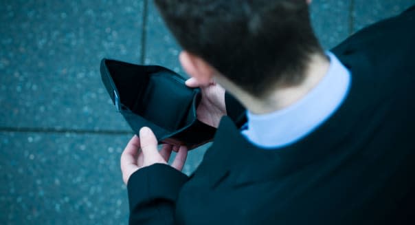 Young businessman checking his wallet