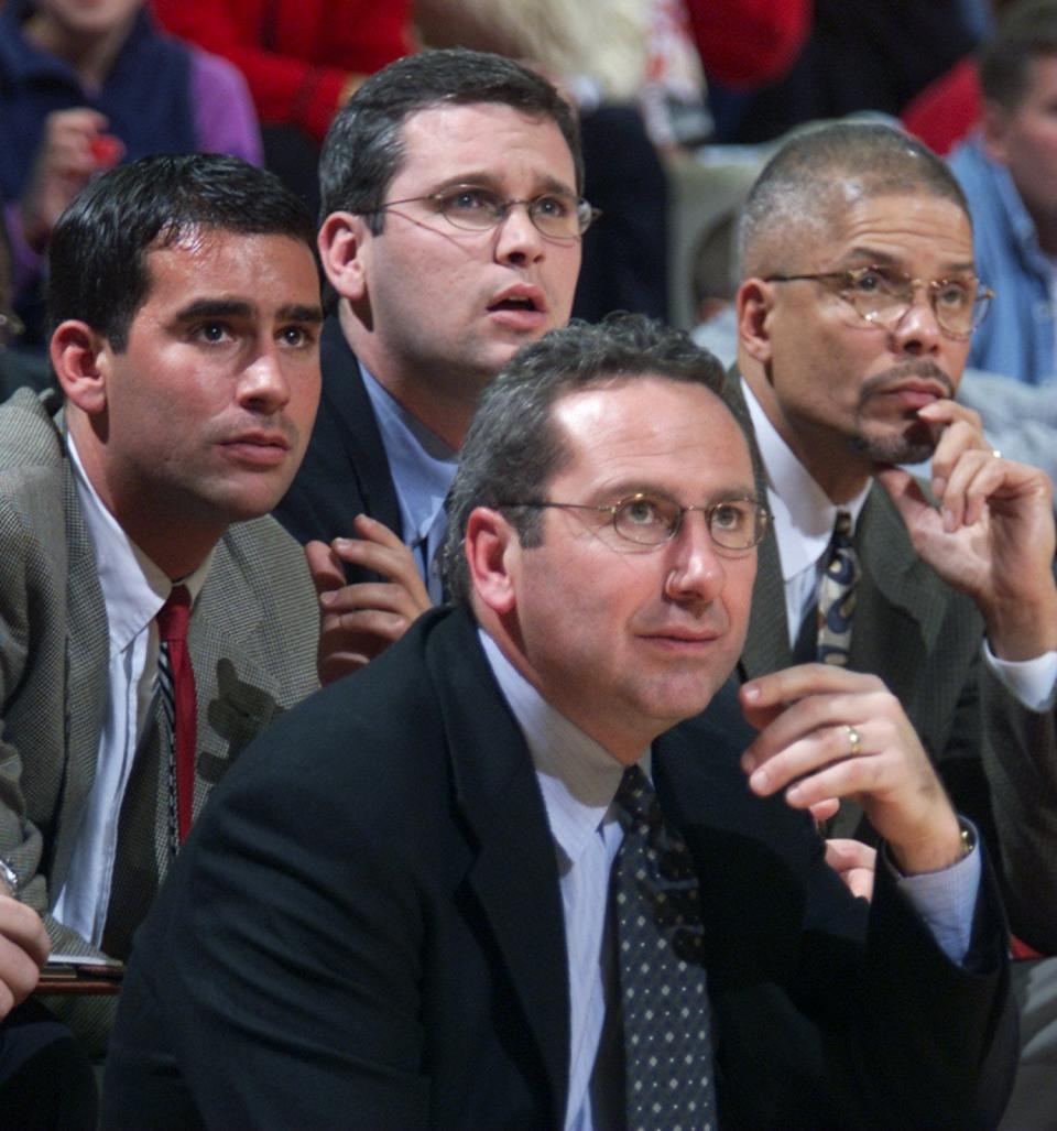 Rutgers Mens basketball coaches Geoff Billet (far left) Dan Hurley (top center) and Associate Head Coach Rod Baker (right) join Head Coach Kevin Bannon (lower center) watch as Rutgers take the win over Fairleigh Dickinson in Piscataway on Nov. 19, 2000.