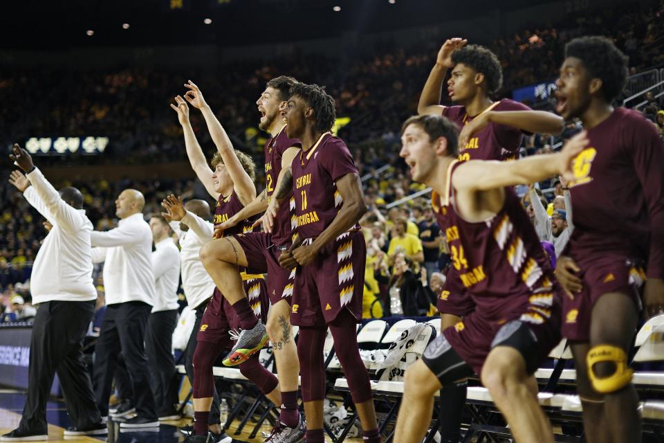 The Central Michigan bench celebrates after a go-ahead 3-point basket by Reggie Bass during the second half of U-M's 63-61 loss to CMU on Thursday, Dec. 29, 2022, at Crisler Center.