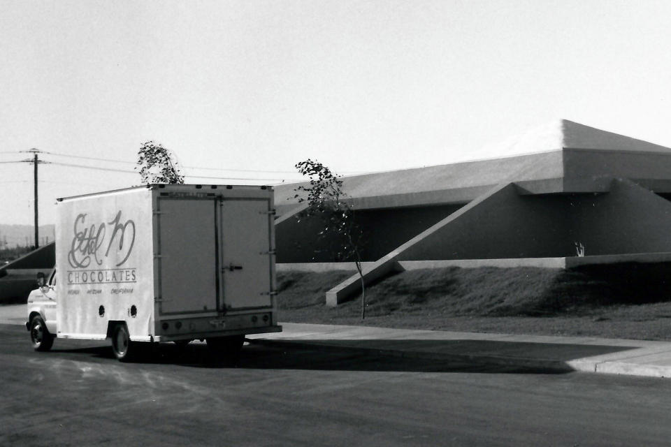 In this undated image provided by Ethel M Chocolates, a delivery truck is seen outside the Ethel M Chocolates building in Henderson, Nev. NASCAR driver Kyle Busch first went to the Ethel M candy factory with his grandmother. It wasn’t a tourist stop to the young Busch, it was a candy store and his grandmother let him roam the cactus garden and rewarded him with the craft chocolates. It comes full circle Sunday at home track Las Vegas Motor Speedway. Ethel M is part of the Mars Corp., the longtime sponsor of Busch’s team. Busch will feature the brand on his car in Sunday’s race. (Ethel M Chocolates via AP)