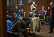 Chinese relatives of passengers aboard a missing Malaysia Airlines plane wait for the latest news inside a hotel room set aside for relatives or friends of passengers aboard the missing airplane in Beijing, China Wednesday, March 12, 2014. The missing Malaysian jetliner may have attempted to turn back before it vanished from radar, but there is no evidence it reached the Strait of Malacca, Malaysia's air force chief said Wednesday, denying reported remarks he said otherwise. The statement suggested continued confusion over where the Boeing 777 might have ended up, more than four days after it disappeared en route to Beijing from Kuala Lumpur with 239 people on board. (AP Photo/Andy Wong)