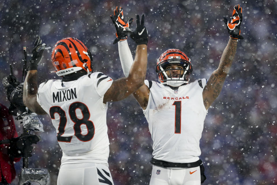 Cincinnati Bengals wide receiver Ja'Marr Chase (1) and Cincinnati Bengals running back Joe Mixon (28) motion for a touchdown against the Buffalo Bills during the third quarter of an NFL division round football game, Sunday, Jan. 22, 2023, in Orchard Park, N.Y. (AP Photo/Joshua Bessex)
