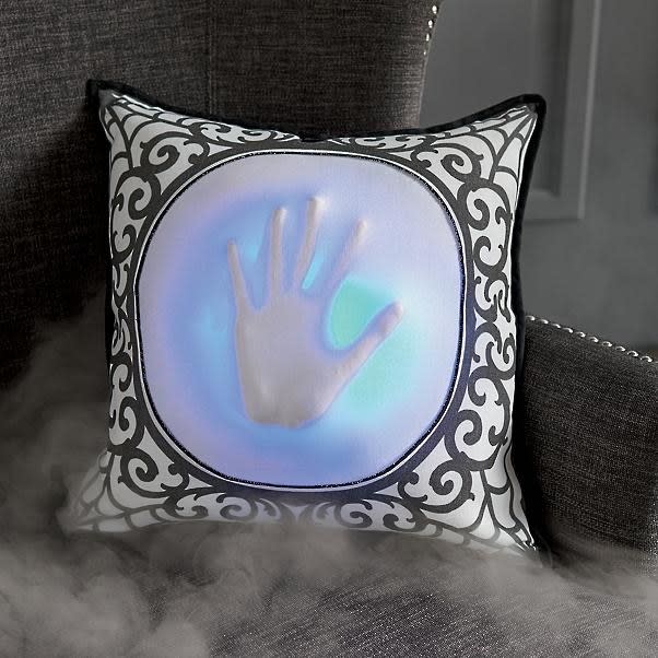 <p>Just when your guests think they can relax on the couch, this animated pillow will have them jumping up in fear.</p> <p><strong>Shop now:</strong> Animated Skeleton Hand Pillow, $79. <a rel="nofollow noopener" href="https://www.grandinroad.com/animated-skeleton-hand-pillow/halloween-haven/lighted-halloween-decor/1187503" target="_blank" data-ylk="slk:grandinroad.com;elm:context_link;itc:0;sec:content-canvas" class="link ">grandinroad.com</a></p>