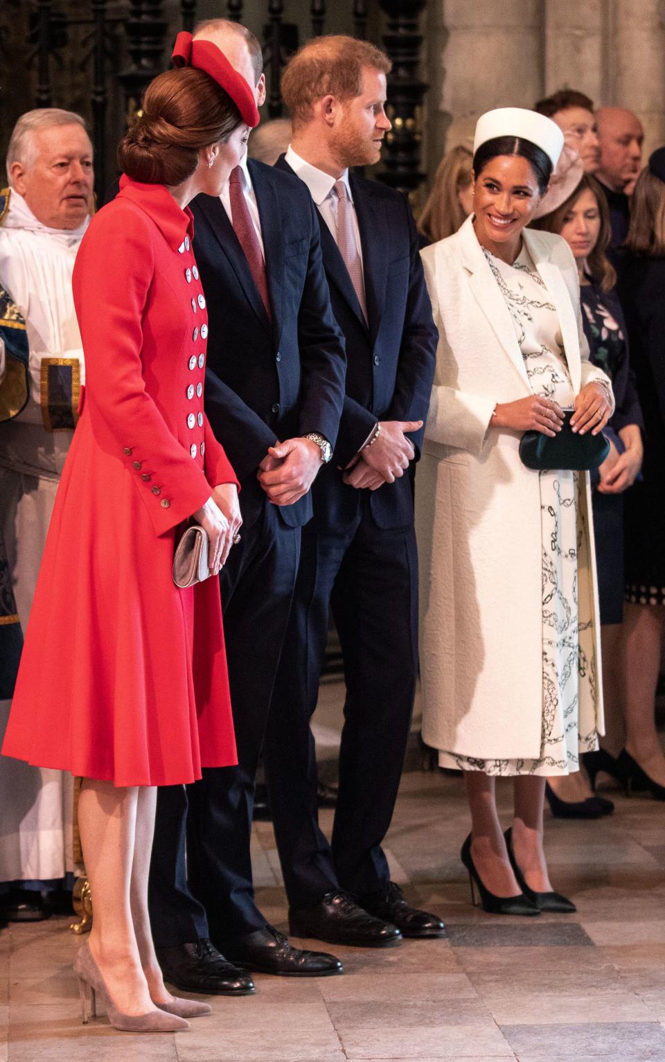 The sisters-in-law appeared to be chatting across their husbands. Photo: Getty