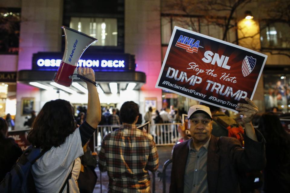 People protest in  front of NBC studios while they are calling for the network to rescind the invitation to Donald Trump to host Saturday Night Live show on November 4, 2015 in New York.