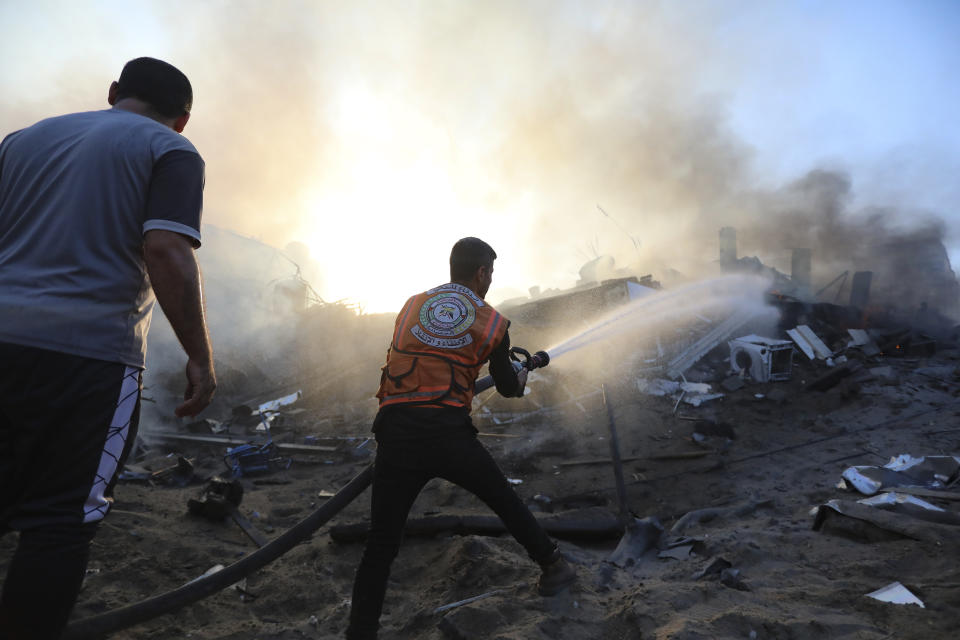 A Palestinian firefighter extinguishes a fire in a destroyed building following Israeli airstrikes on Gaza City, Wednesday, Oct. 25, 2023. (AP Photo/Abed Khaled)