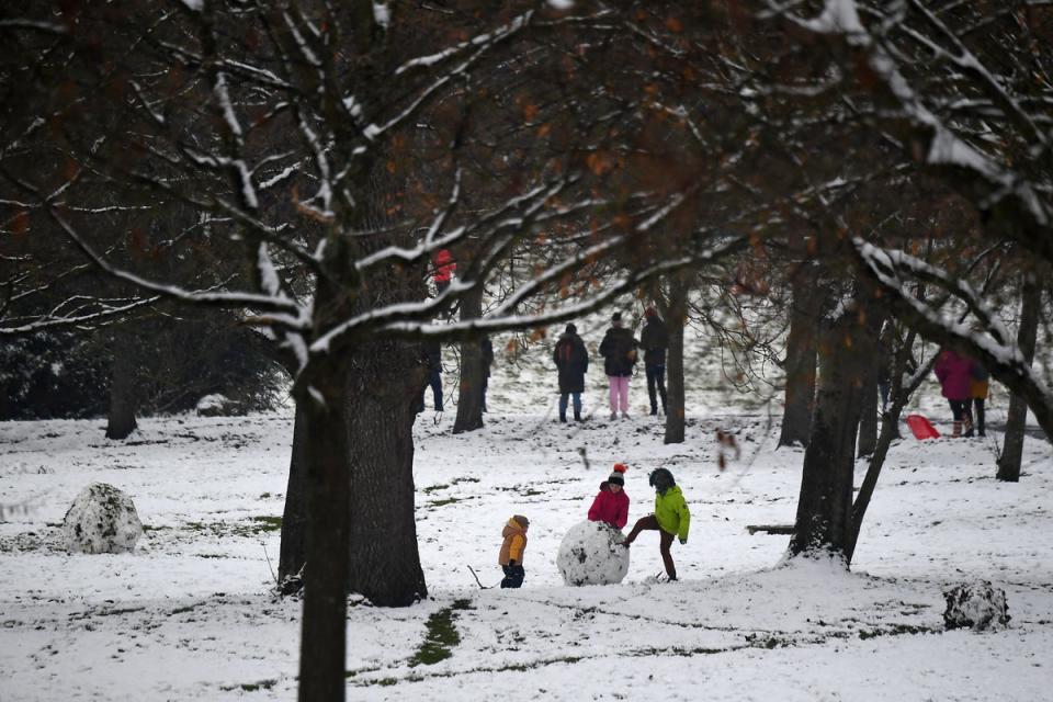 Children play in the snow in Glasgow’s Victoria Park (Getty)