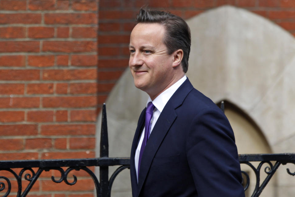 British Prime Minister David Cameron arrives to give evidence at the Leveson inquiry at the Royal Courts of Justice in central London, Thursday, June 14, 2012. The judge-led inquiry was set up following revelations of phone hacking at Murdoch's News of the World tabloid. The scandal has shaken the British establishment and raised questions about whether top politicians helped shield Murdoch from scrutiny. (AP Photo/Lefteris Pitarakis)