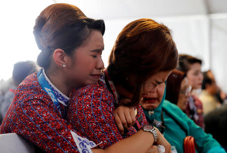 Coleagues of crew of Lion Air flight JT610 cry on the deck of Indonesia Navy ship KRI Banjarmasin as they visit the site of the crash to pay their tribute, at the north coast of Karawang, Indonesia, November 6, 2018. REUTERS/Beawiharta/Files