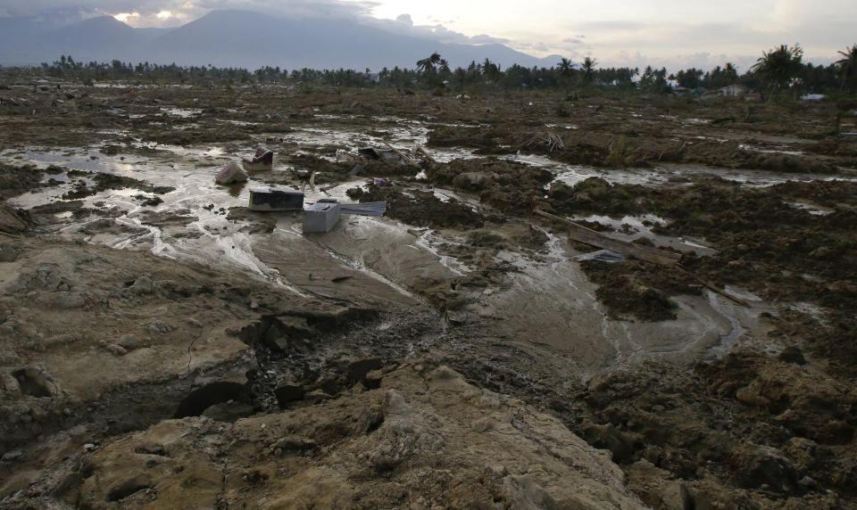 In this Oct. 6, 2018, photo, pieces of furniture sit in the mud-covered Balarola neighborhood of Palu city where a massive earthquake caused the soil to loosen like a liquid, swallowing some homes whole and collapsing others into piles of rubble in Central Sulawesi, Indonesia. The 7.5 magnitude quake triggered not just a tsunami that leveled huge swathes of the region's coast, but a geological phenomenon known as liquefaction, making the soil move like liquid and swallowing entire neighborhoods. (AP Photo/Aaron Favila)