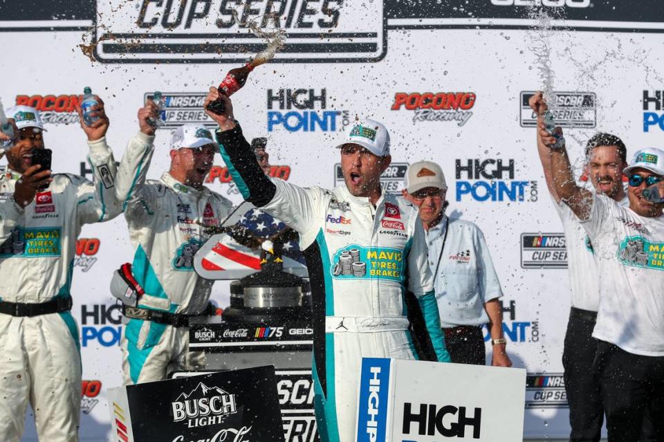 NASCAR Cup Series driver Denny Hamlin celebrates in victory lane after winning the HighPoint.com 400 at Pocono Raceway.