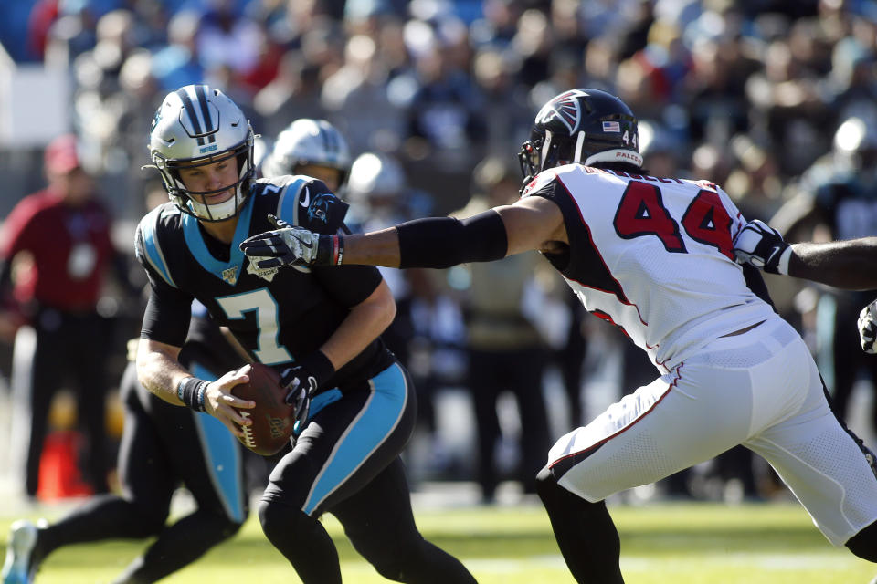Carolina Panthers quarterback Kyle Allen (7) scramles while Atlanta Falcons defensive end Vic Beasley (44) rushes during the first half of an NFL football game in Charlotte, N.C., Sunday, Nov. 17, 2019. (AP Photo/Brian Blanco)