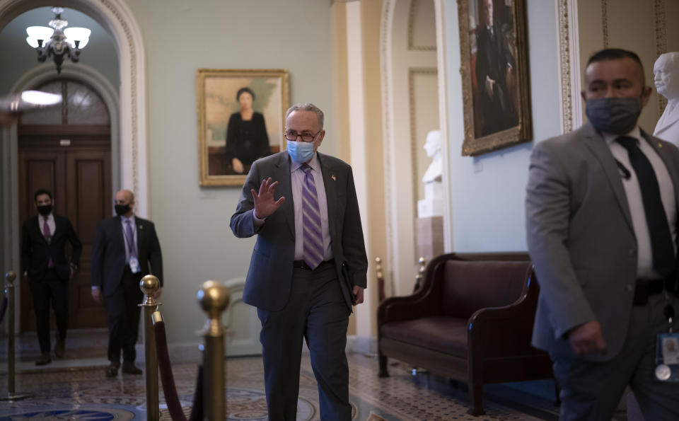 Senate Majority Leader Chuck Schumer, D-N.Y., waves as he walks on Capitol Hill at the conclusion of the first day of the second impeachment trial of former President Donald Trump in the Senate on Capitol Hill Tuesday, Feb. 9, 2021, in Washington. (AP Photo/J. Scott Applewhite)