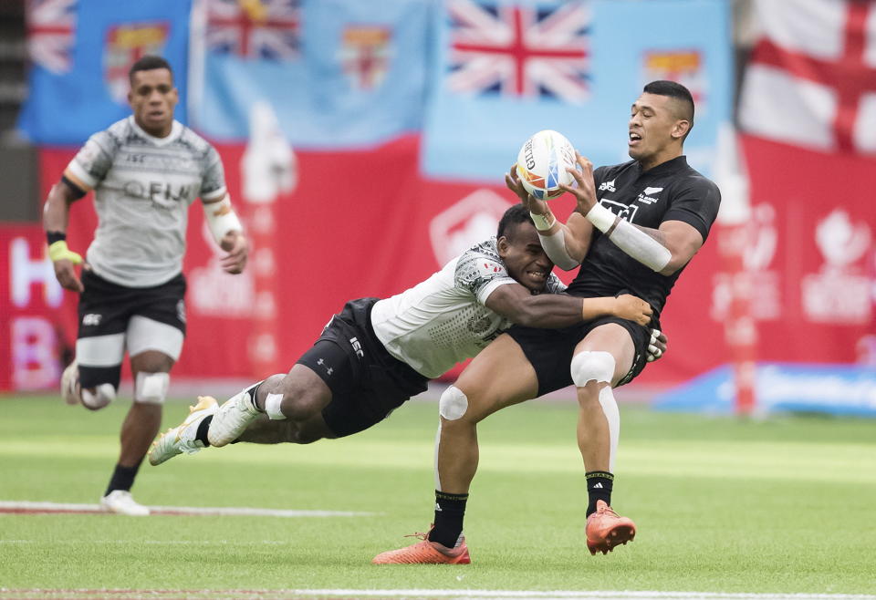 New Zealand's Etene Nanai-Seturo, right, is tackled by Fiji's Napolioni Bolaca during a quarterfinal match at the Canada Sevens rugby tournament in Vancouver, British Columbia, Sunday, March 8, 2020. (Darryl Dyck/The Canadian Press via AP)