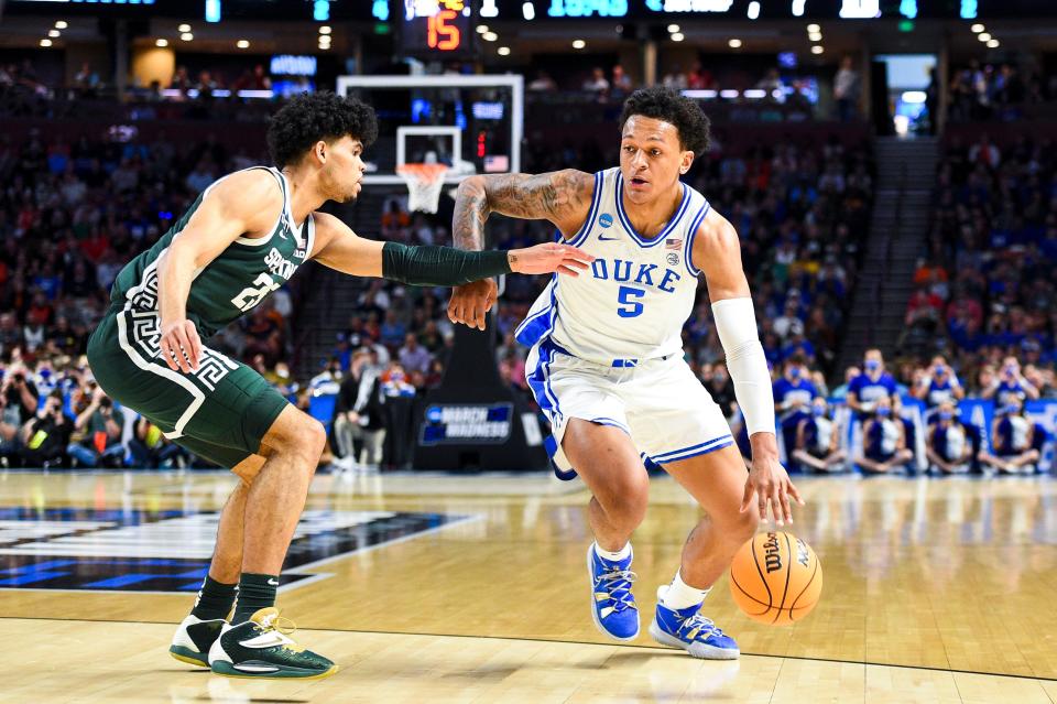 Mar 20, 2022; Greenville, SC, USA; Duke Blue Devils forward Paolo Banchero (5) carries the ball against Michigan State Spartans forward Malik Hall (25) in the first half during the second round of the 2022 NCAA Tournament at Bon Secours Wellness Arena.