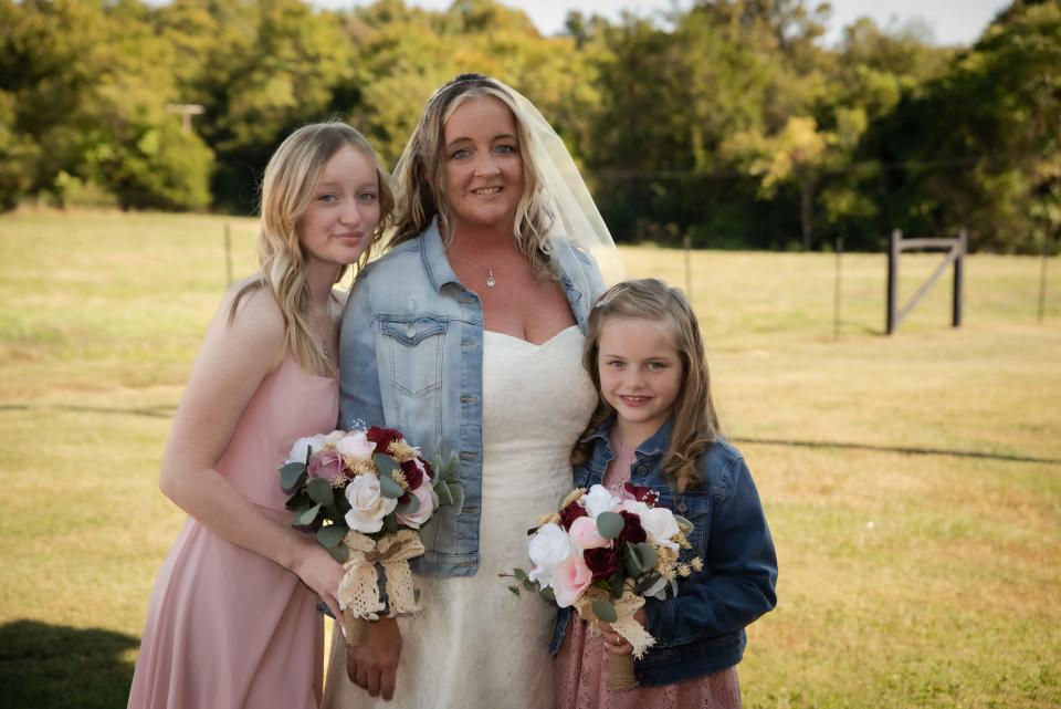 Samantha Snellen, center, poses with her daughters Michaela, 15, and Kynlee, 8, on her wedding day on Oct. 9, 2022.