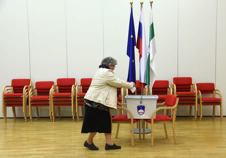 A woman casts her vote at a polling station during the presidential election in Grosuplje, Slovenia October 22, 2017. REUTERS/Borut Zivulovic