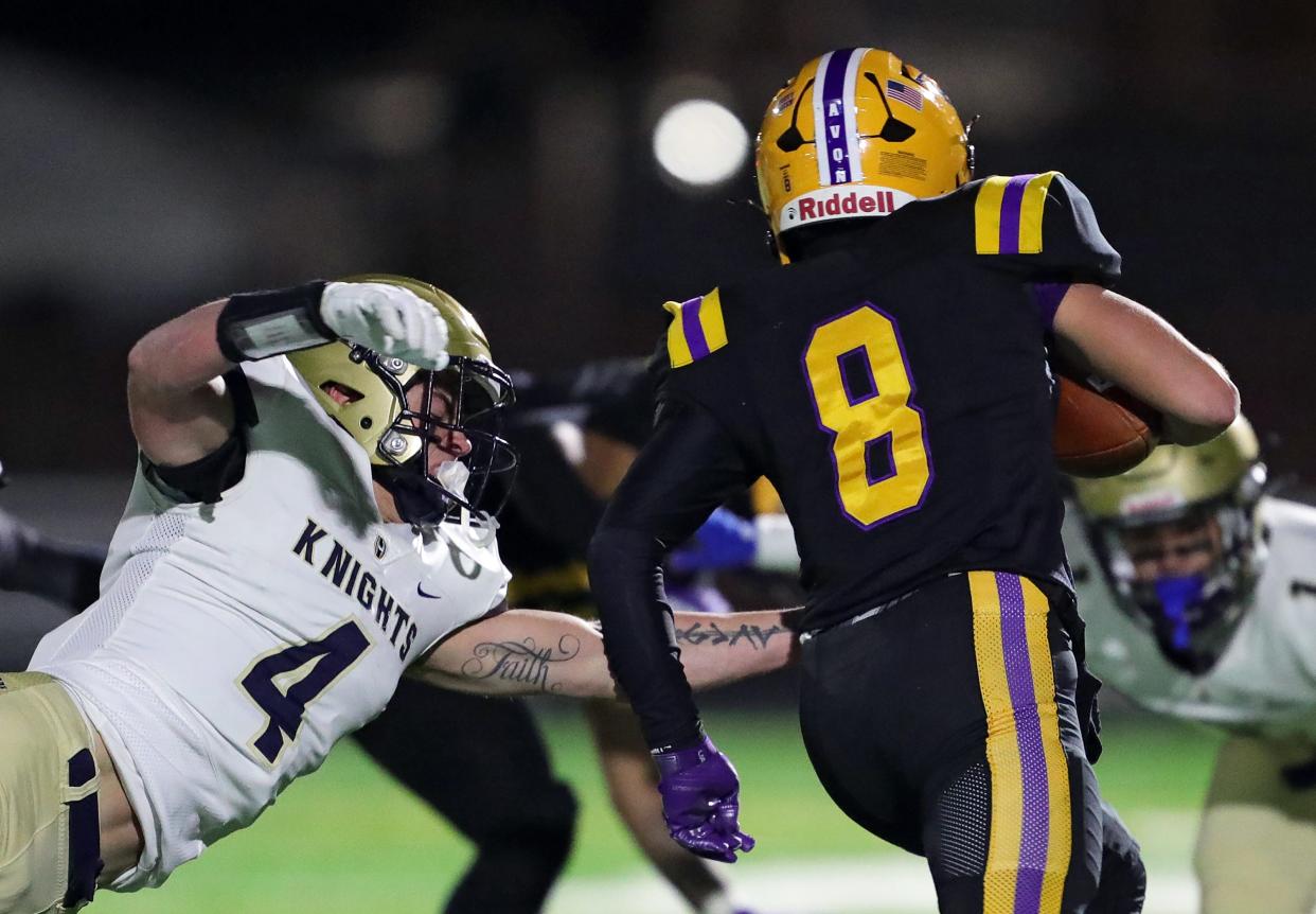 Hoban linebacker Tanner Mintz, left, reaches out to tackle wide receiver Matt Maxey during the first half of the Division II state semifinal, Friday, Nov. 24, 2023, in Parma.