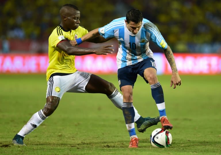 Argentina's Angel Di Maria (R) is marked by Colombia's Helibelton Palacios during the Russia 2018 FIFA World Cup South American Qualifiers football match, in Barranquilla, Colombia, on November 17, 2015