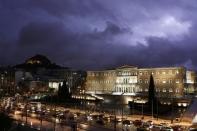 A storm illuminates the sky over the Greek parliament in Athens January 24, 2013. REUTERS/Yorgos Karahalis