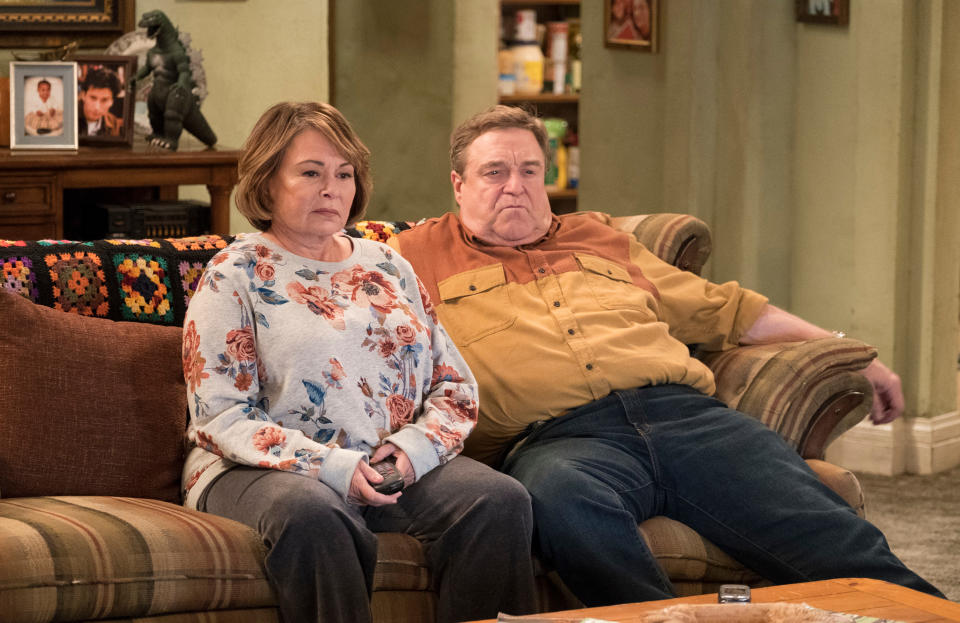 In this image released by ABC, Roseanne Barr, left, and John Goodman appear in a scene from the comedy series "Roseanne." The comedy about the blue-collar Conner family and its brassy matriarch returned in March as a success for ABC and Roseanne Barr but was canceled in May after Barr’s racist slam of Obama adviser Valerie Jarrett. ABC called her tweet “abhorrent." (Adam Rose/ABC via AP)