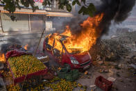 Cars of protesters opposing a new citizenship law is set ablaze by protesters supporting a new citizenship law during clashes between two groups over the Citizenship Amendment Act on February 24, 2020 in Delhi, India. An Indian policemen and a civilian were killed as clashes erupted between two groups over the Citizenship Amendment Act, a controversial law passed by the Indian government that has led to protests over fears that it will be used to strip the country's Muslim population of their citizenship. Demonstrations were held in Shaheen Bagh, a Muslim majority locality where hundreds of women are holding a sit-in protest over past the two months, against the visit of US President Donald Trumps to India. (Photo by Yawar Nazir/ Getty Images)