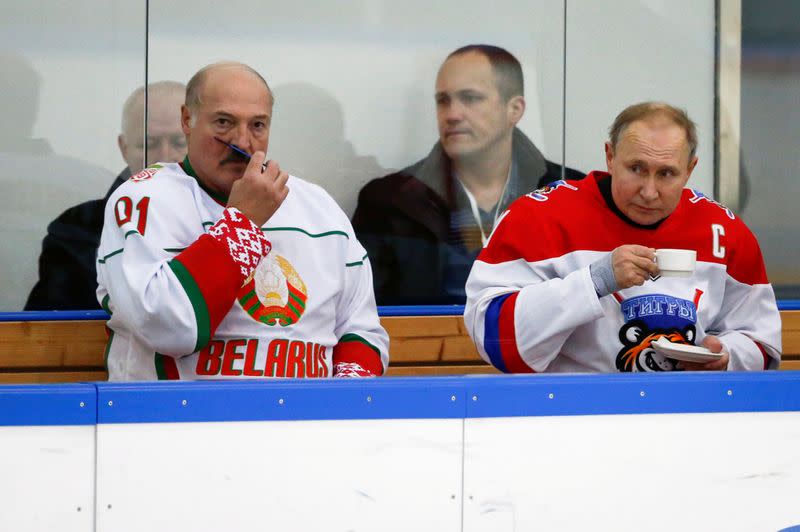 FILE PHOTO: Russian President Vladimir Putin and Belarusian President Alexander Lukashenko take a break during a match of the Night Hockey League teams in Rosa Khutor in the Black Sea resort of Sochi