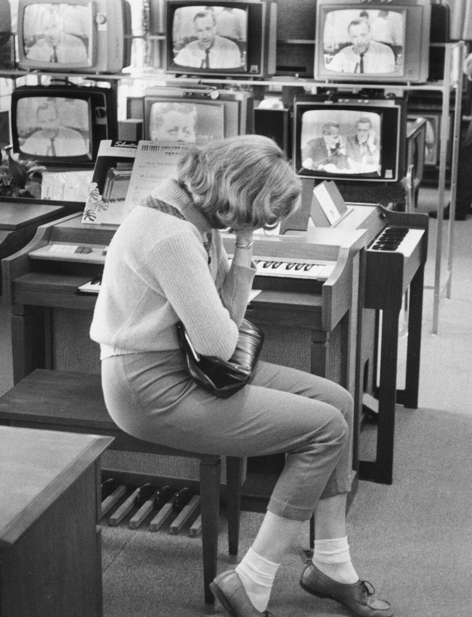 As televisions report news of the assassination of President John F. Kennedy, a woman weeps in a Sears department store in Levittown, Pa. <a href="https://www.gettyimages.com/detail/news-photo/as-televisions-in-the-background-report-news-of-the-news-photo/1396714258" rel="nofollow noopener" target="_blank" data-ylk="slk:Jack Rosen/Getty Images;elm:context_link;itc:0;sec:content-canvas" class="link ">Jack Rosen/Getty Images</a>