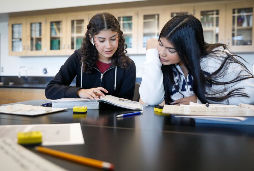 MAYWOOD-CA - DECEMBER 19, 2022: Students Ana Menbreno, left, and Carolina Gomez take a biology class at Maywood Center for Enriched Studies Magnet in Maywood during "acceleration days," two days of optional learning that were moved from the middle of the school calendar to the first two weekdays of winter break, on Monday, December 19, 2022. (Christina House / Los Angeles Times)