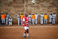 A prisoner warms up before the start of a mock World Cup soccer match between Russia and Saudi Arabia, as part of a month-long soccer tournament involving eight prison teams at the Kamiti Maximum Prison, Kenya's largest prison facility, near Nairobi, Kenya, June 14, 2018. REUTERS/Baz Ratner