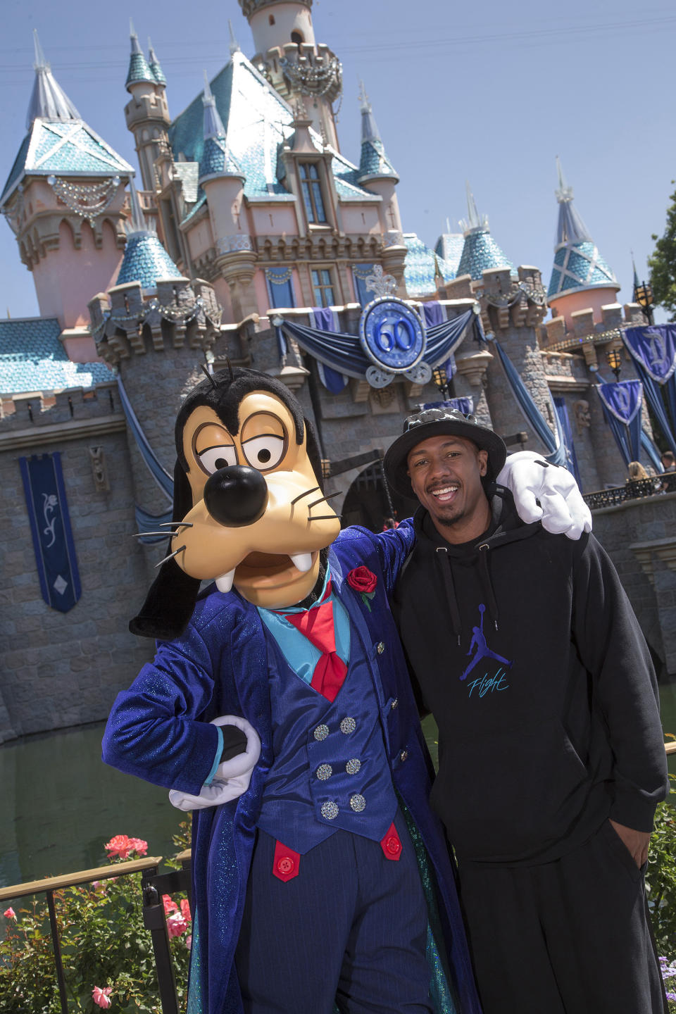 <p>ANAHEIM, CA - JUNE 19: Nick Cannon poses with Goofy in his new 60th Anniversary-themed suit in front of Sleeping Beauty Castle.</p>