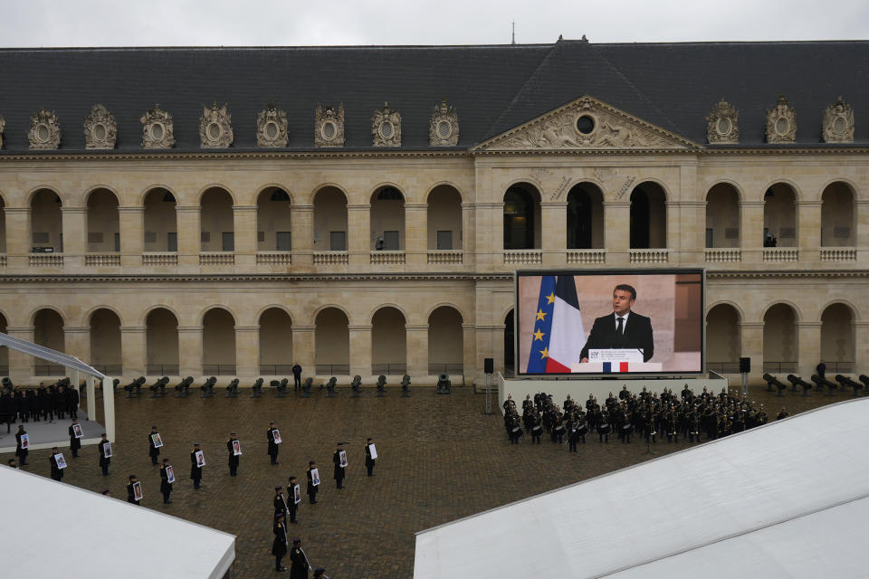 Photographs of the French victims of the Hamas' Oct.7 2023 attack are displayed as French President Emmanuel Macron speaks, during a ceremony at the Invalides monument, Wednesday, Feb.7, 2024. France is paying tribute Wednesday to French victims of Hamas' Oct. 7 attack, in a national ceremony led by President Emmanuel Macron four months after the deadly assault in Israel that killed some 1,200 people, mostly civilians, and saw around 250 abducted. (AP Photo/Thibault Camus)