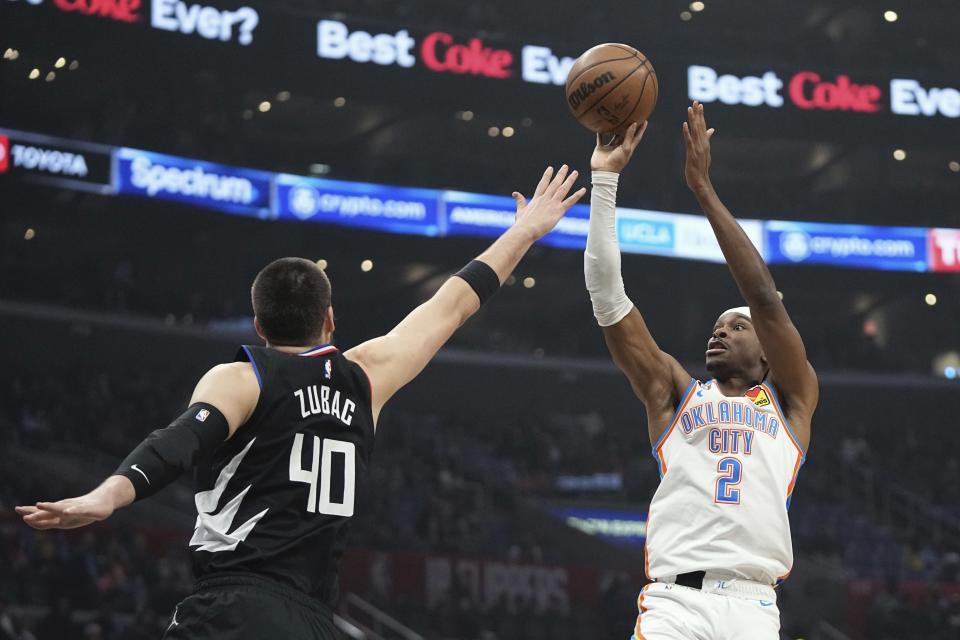 Oklahoma City Thunder guard Shai Gilgeous-Alexander, right, shoots as LA Clippers center Ivica Zubac defends during the first half of an NBA basketball game Thursday, March 23, 2023, in Los Angeles. (AP Photo/Mark J. Terrill)