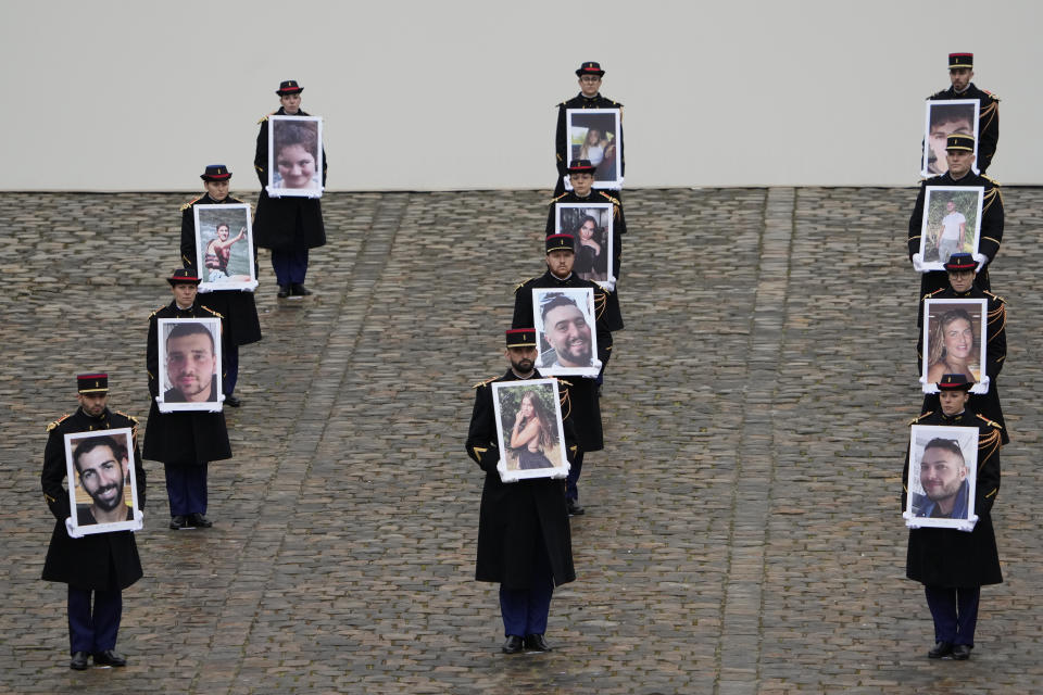Photographs of the French victims of the Hamas' Oct.7 2023 attack are displayed during a ceremony at the Invalides monument, Wednesday, Feb.7, 2024. France is paying tribute Wednesday to French victims of Hamas' Oct. 7 attack, in a national ceremony led by President Emmanuel Macron four months after the deadly assault in Israel that killed some 1,200 people, mostly civilians, and saw around 250 abducted. (AP Photo/Thibault Camus)