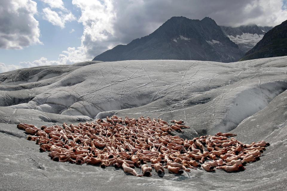 Naked volunteers pose for Tunick in the ice-cold Swiss glacier of Aletsch, the largest in the Alps, as background for an environmental campaign about global warming August 18, 2007. The campaign organized by Greenpeace was aimed at drawing attention to melting Alpine glaciers, a clear sign of global warming and man-made climate change according to the organization.