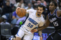 Orlando Magic guard Cole Anthony (50) drives to the basket while defended by Sacramento Kings guard Davion Mitchell (15) during the second half of an NBA basketball game in Sacramento, Calif., Wednesday, Dec. 8, 2021. (AP Photo/Jose Luis Villegas)