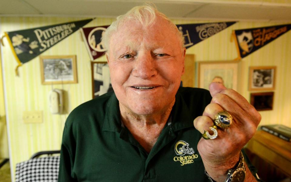 Gary Glick holds up a fist with two of his three championship rings at his home on May 6, 2014.