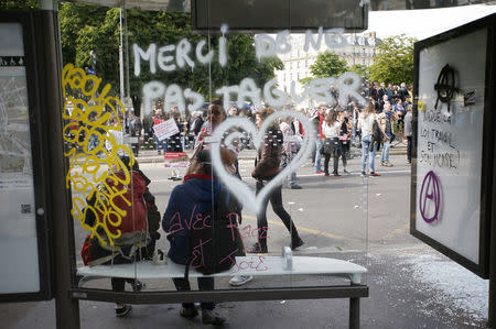 A message is written on bus stop which was attacked by youths who took part in a demonstration in protest of the government's proposed labour law reforms in Paris, France, May 26, 2016. REUTERS/Charles Platiau