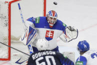 Slovakia's goaltender Adam Huska in action during the Ice Hockey World Championship quarterfinal match between the United States and Slovakia at the Arena in Riga, Latvia, Thursday, June 3, 2021.(AP Photo/Sergei Grits)