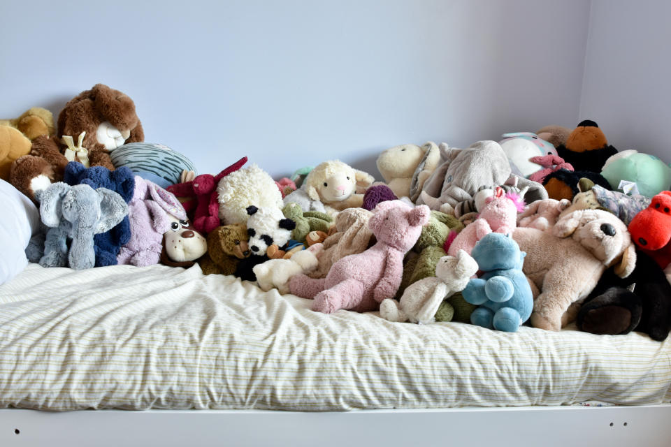 a bed with a bunch of plushies