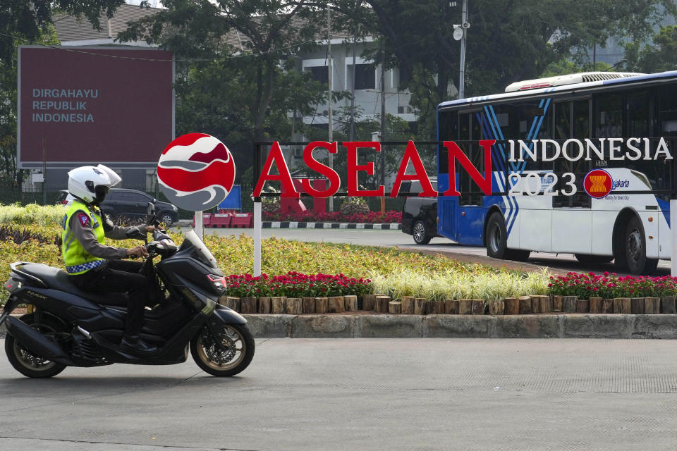 A Police officer rides his motorbike past an ASEAN 2023 logo in Jakarta, Indonesia Friday, Sept. 1, 2023. Southeast Asian leaders led by Indonesian host President Joko Widodo are gathering in their final summit this year, besieged by divisive issues with no solutions in sight: Myanmar’s deadly civil strife, new flare-ups in the disputed South China Sea, and the longstanding United States-China rivalry.(AP Photo/Tatan Syuflana)