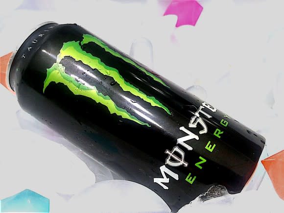 A can of Monster Energy resting on a bed of ice.