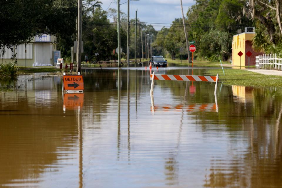 Floodwaters remain high Saturday on West New York Avenue in Fellsmere following two days of severe rainfall.